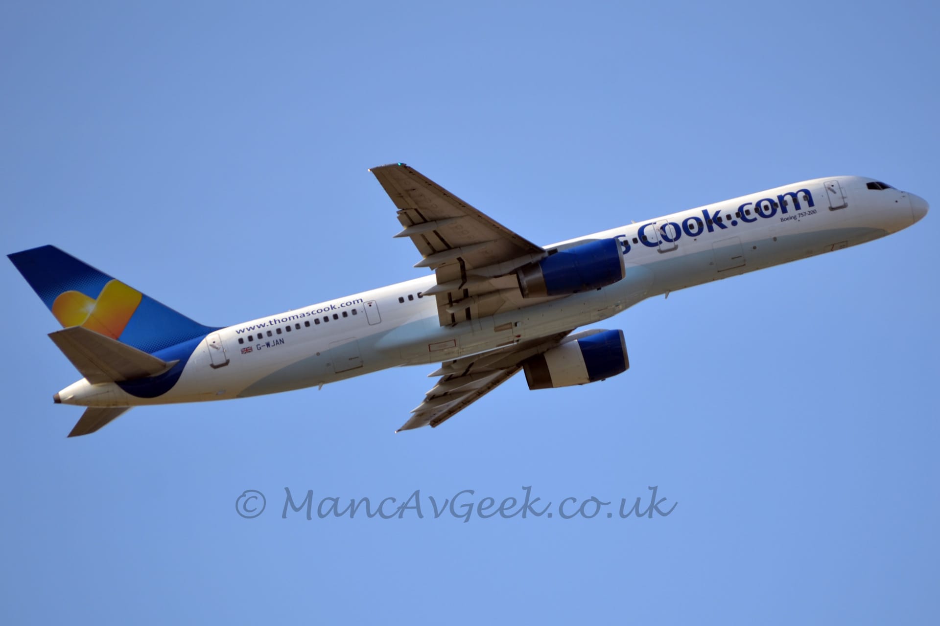 Low side view of a twin engined jet airliner flying from left to right at a low altitude, with undercarriage already tucked away, flaps extended from the rear of the wings, and the nose raised sharply, suggesting it has just taken off.