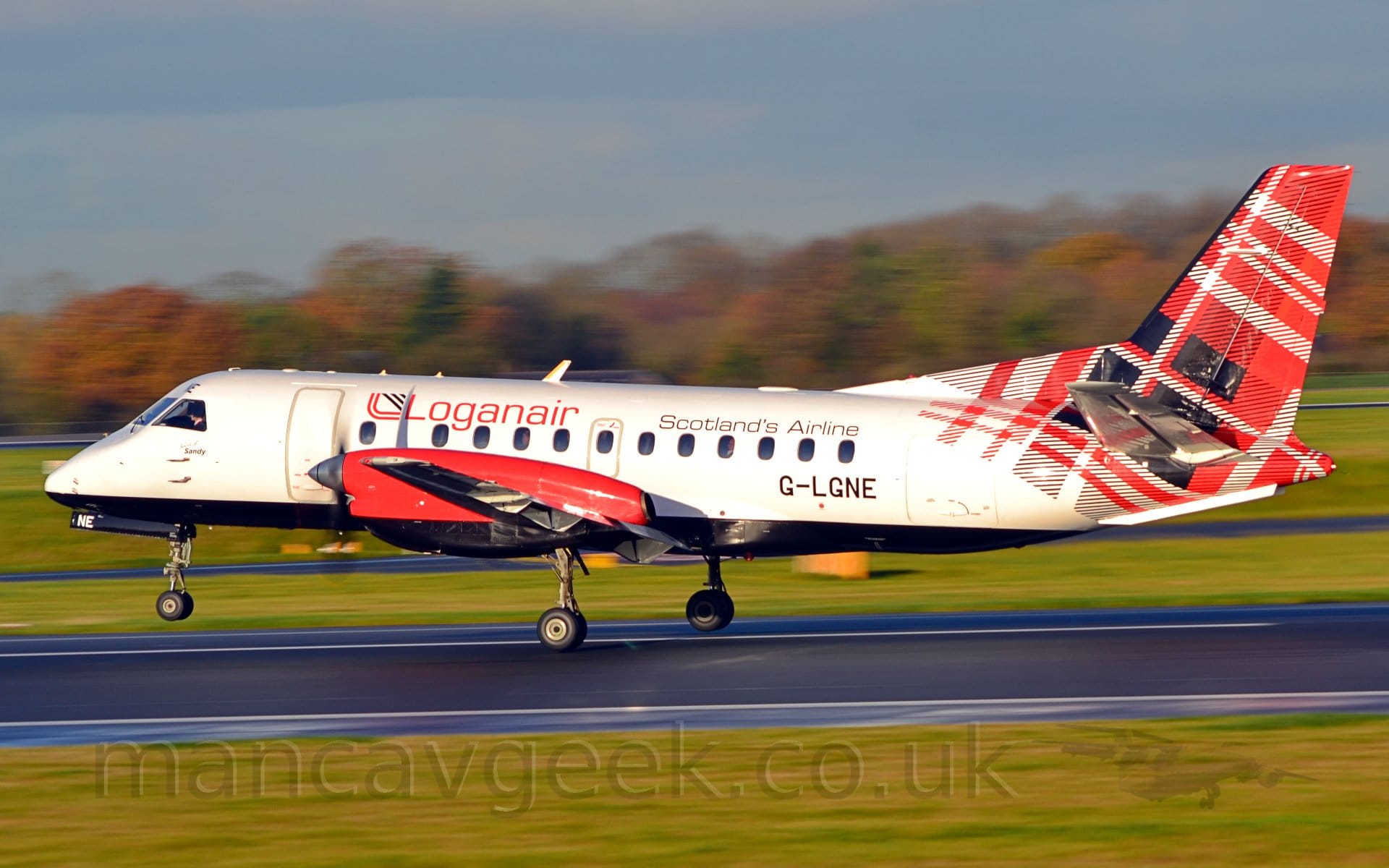 Side view of a white, twin propellor-engined airliner  just leaving a black runway, moving from right to left, it's nosewheel in the air,