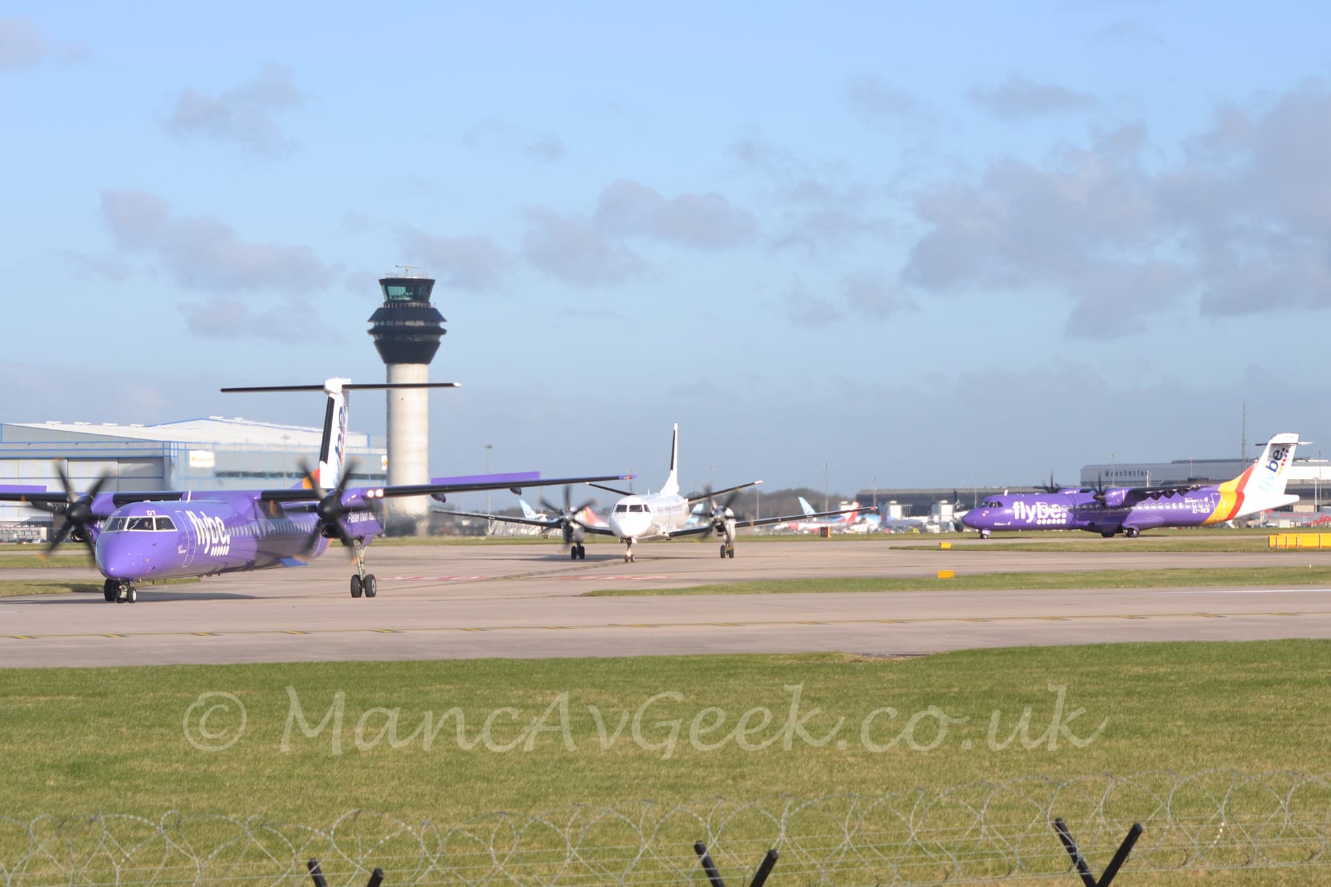 3 different types of airliner in 2 different colour schemes taxiing from right to left at a busy airport.