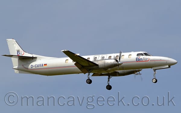 Side view of a long, thin, twin propellor-engined airliner flying from left to right