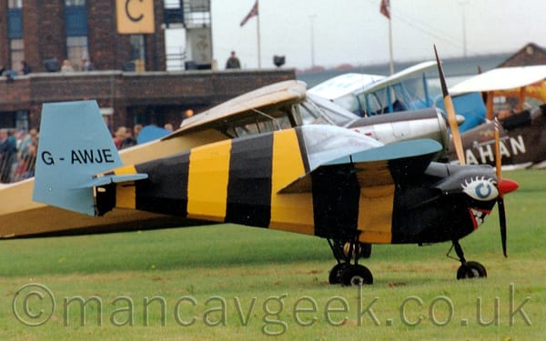 Side view of a very small, single engined light aircraft vaguely resembling a bumble bee.