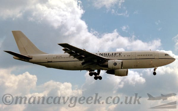 Side view of a white, twin engined jet airliner flying from left to right at a low altitude