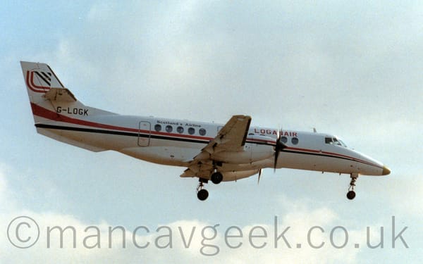 Side view of a white, twin propellor-engined airliner flying from left to right at a low altitude