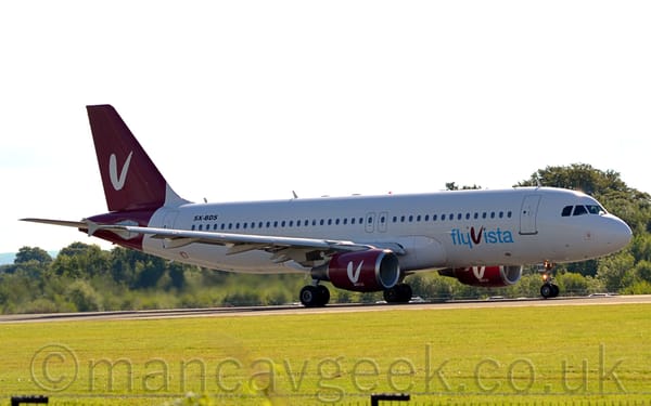 Side view of a white, twin-engined jet airliner taxiing from left to right.