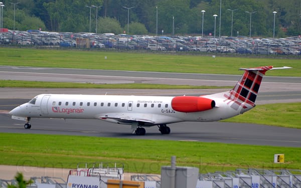 Side view of a white, twin engined jet airliner taxiing from right to left.