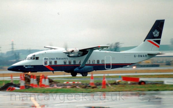 Side view of a high-winged, twin propellor-engined airliner taxiing from right to left.