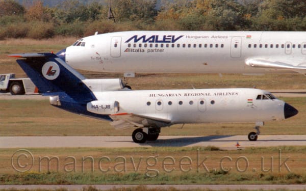 Side view of a 3 engined jet airliner with the engines mounted on the rear of the fuselage, taxiing from left to right.