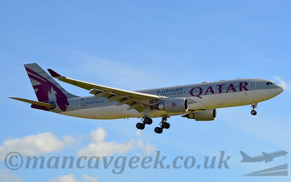 Side view of a twin engined jet airliner flying from left to right at a very low altitude