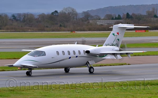 Side view of a twin propellor-engined, white BizProp with the engines mounted facing backwards on the wings.