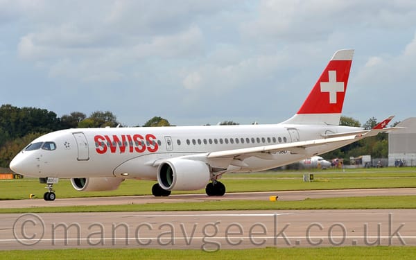 Side view of a rather sleek-looking, white, twin engined jet airliner taxiing from right to left.