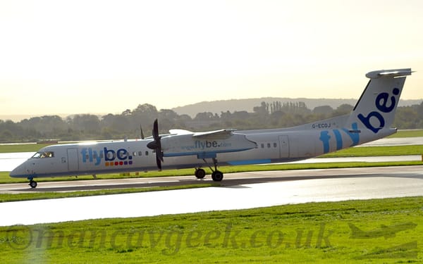 Side view of a high-winged, twin propellor-engined airliner taxiing from right to left.