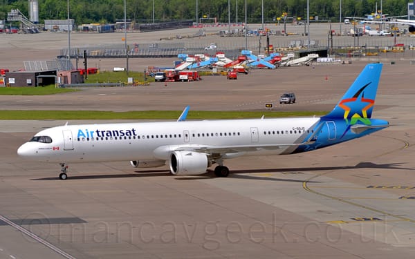 Side view of a twin engined jet airliner taxiing from right to left.