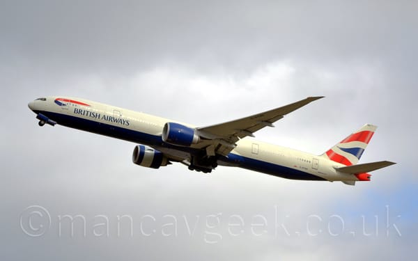Side view of a large, twin engined jet airliner flying from right to left at a low altitude